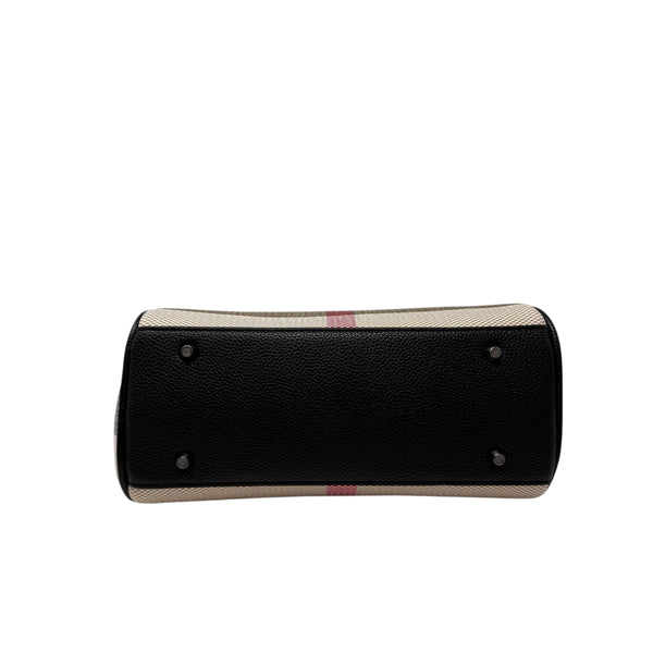 Bottom view of a La Maison du Bleuet structured vegan leather handbag with protective metal feet in black.